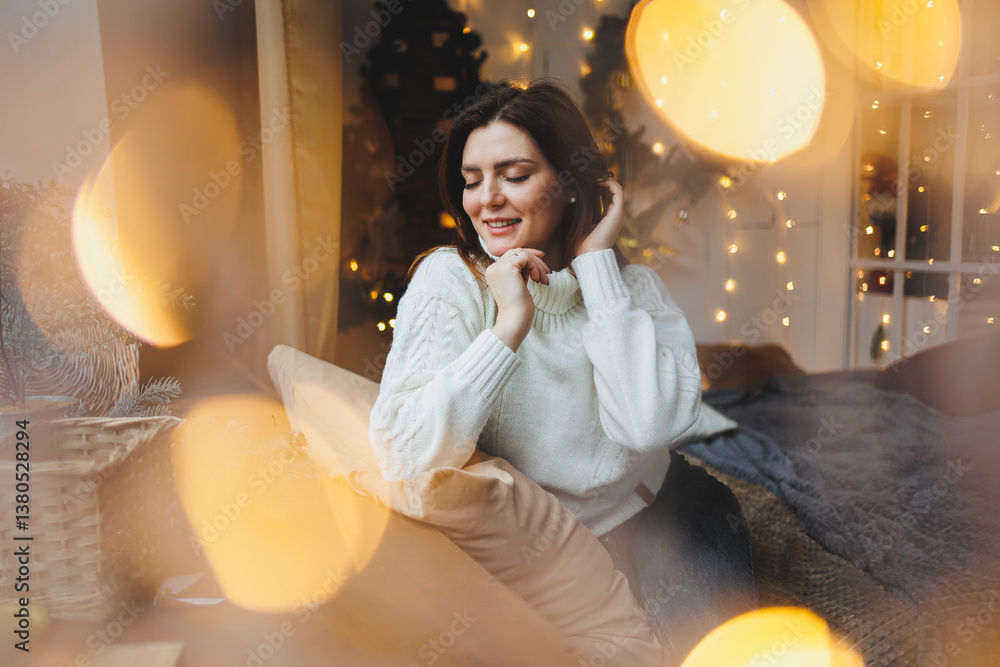 Cute girl in New Year's locations in a cozy living room. Woman at home for the new year.