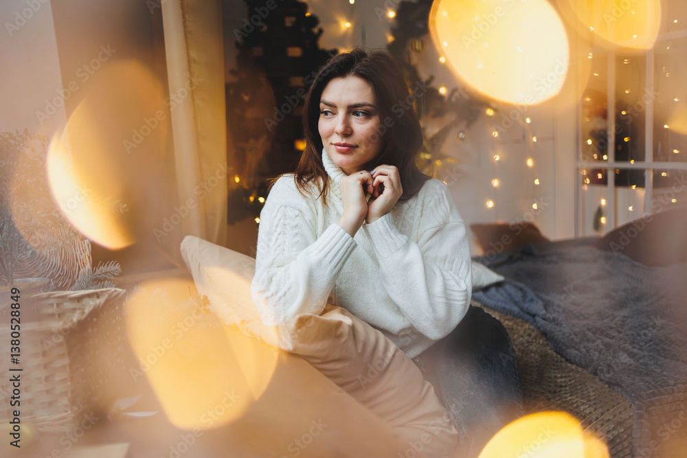 Cute girl in New Year's locations in a cozy living room. Woman at home for the new year.