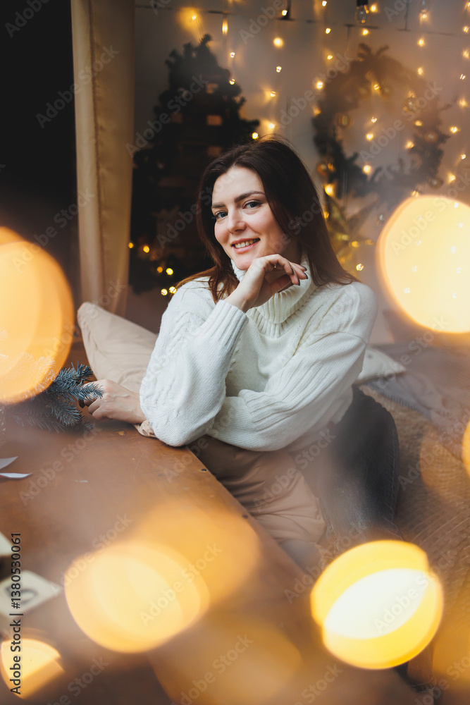 Cute girl in New Year's locations in a cozy living room. Woman at home for the new year.