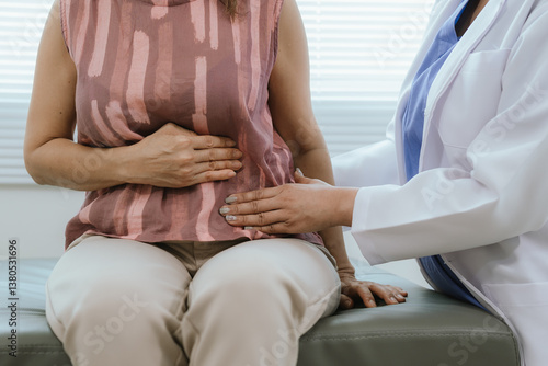 Cuadro en lienzo A female doctor examines an elderly woman with abdominal pain