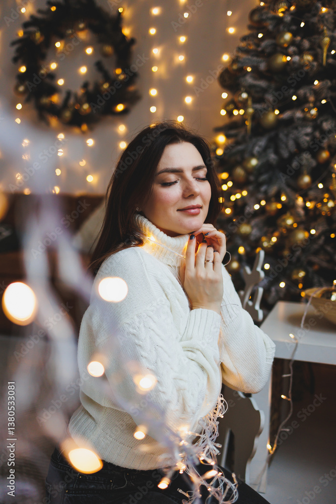 Cute girl in New Year's locations in a cozy living room. Woman at home for the new year.