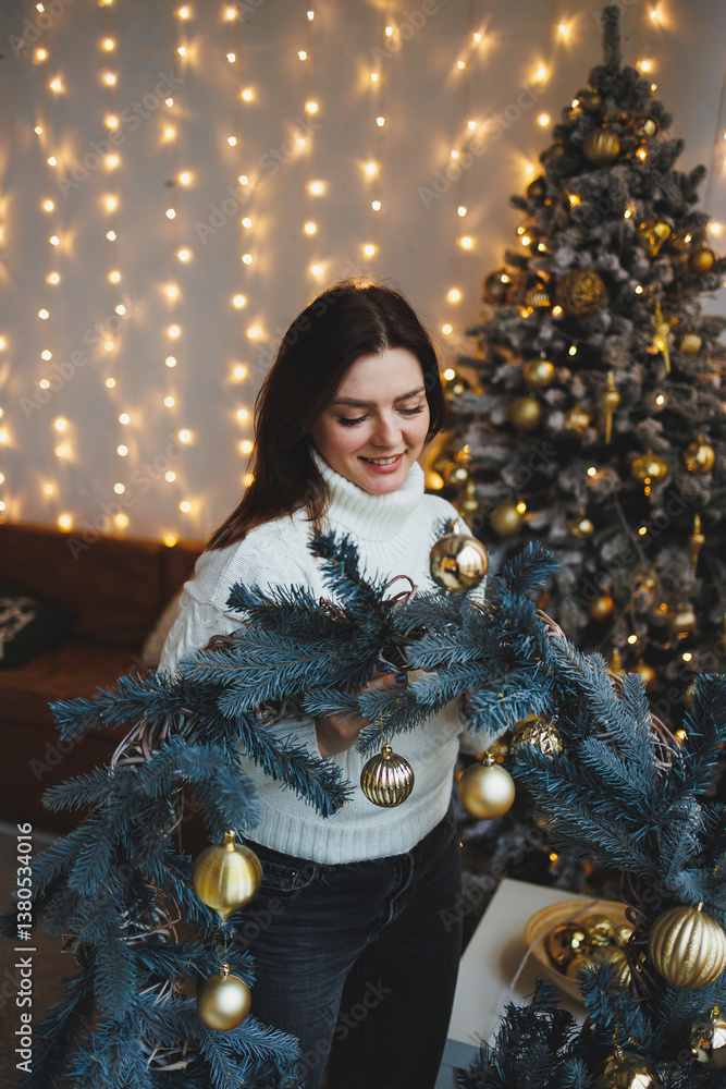 Cute girl in New Year's locations in a cozy living room. Woman at home for the new year.