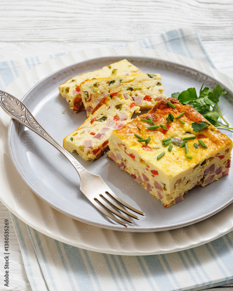 Baked Denver Omelette on a plate with fork Baked Denver Omelette on a plate with fork