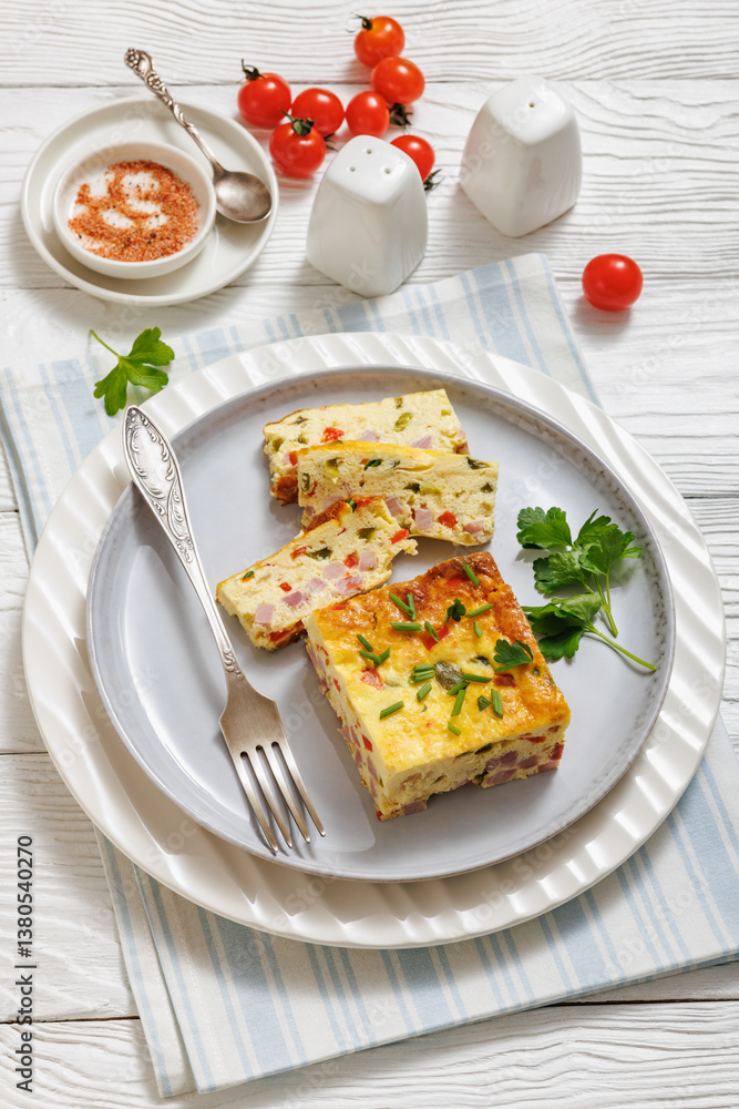 Baked Denver Omelette on a plate with fork Baked Denver Omelette on a plate with fork