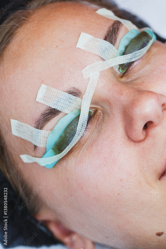 Closeup of a woman in a beauty treatment, using eye protection for safety and comfort. This highlights hygiene, relaxation, satisfaction, and the importance of skincare and selfcare