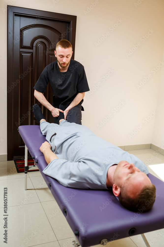 A professional therapist is delivering physical therapy treatment to a client in a modern, wellequipped clinic, ensuring the best possible care and support for their recovery and wellness journey