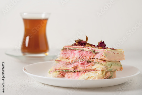 Obraz na płótnie Tasty breakfast with tea handicraft and pink chocolate with airy filling white and pink pismaniye on marble table. Trendy Turkish candy. Close up. w salonie