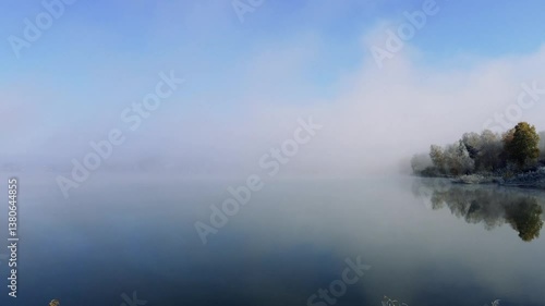 thick morning fog in the summer forest near the reservoir