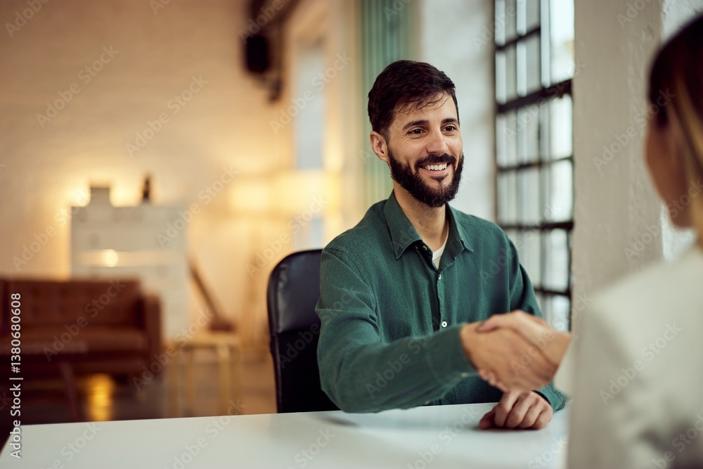 Fototapeta premium Two Professionals Shaking Hands During a Business Meeting in a Bright Office