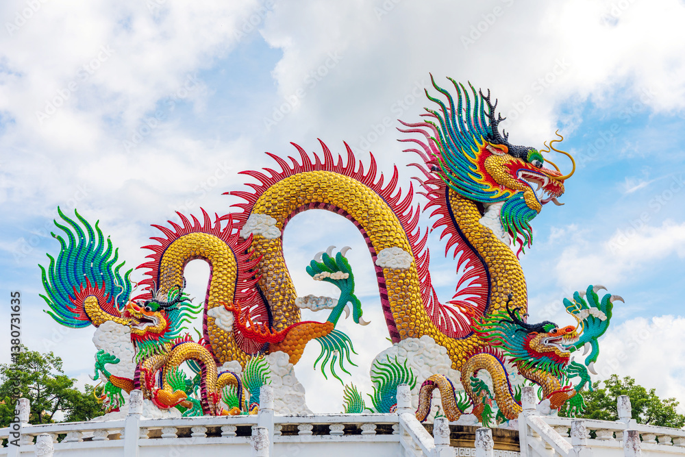 Fototapeta premium Beautiful giant or big colorful dragon statue with blue sky at Nakornsawan Park, Thailand.
