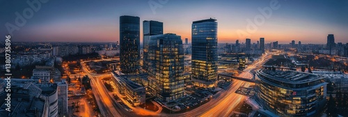 Aerial view of a vibrant modern business district at dusk, with tall glass skyscrapers illuminated by city lights, captured in long exposure style with vivid blue and orange hues.