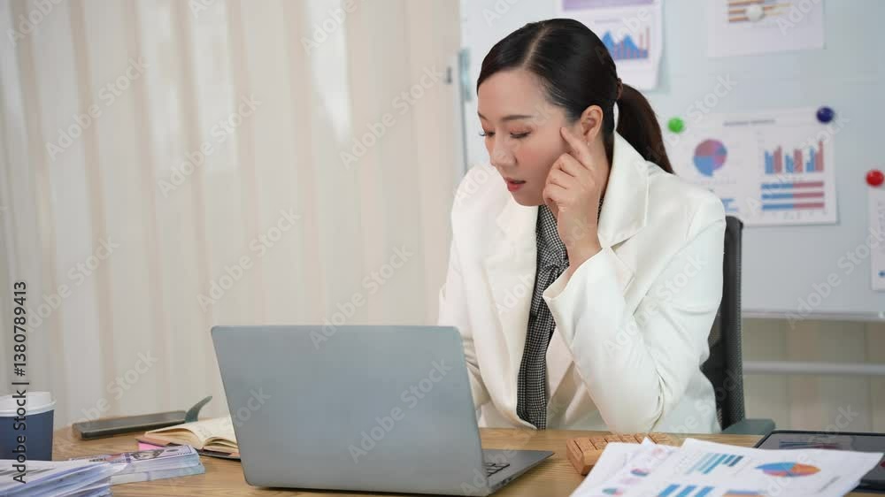 Asian businesswoman in formal suit holds tablet in modern office with financial analysis professional success chart Asian businesswoman in formal suit holds tablet in modern office with financial analysis professional success chart