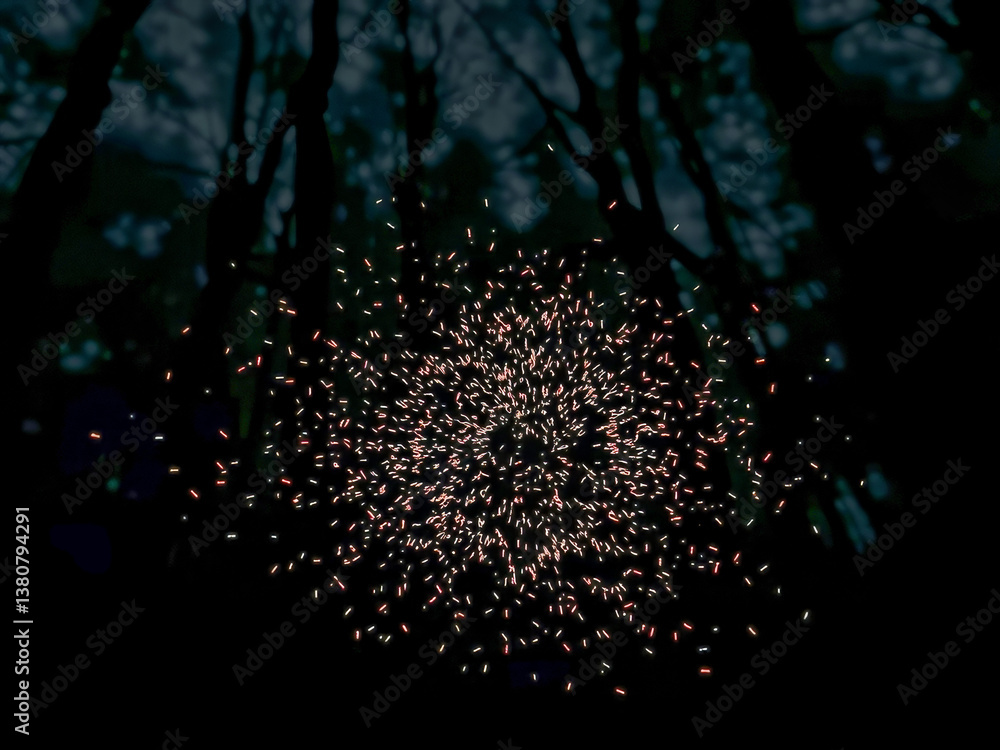 A firework display in the woods at night. The firework display is in the middle of the woods and is surrounded by trees. The firework display is lit up and is creating a beautiful