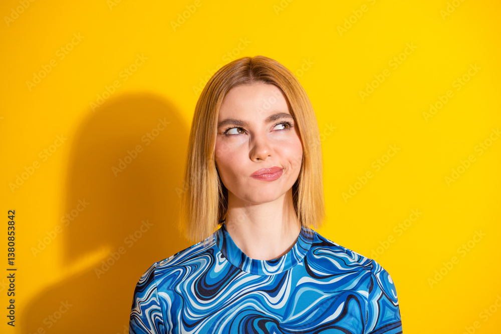 Young woman with stylish fashion top posing against a vibrant yellow background Young woman with stylish fashion top posing against a vibrant yellow background