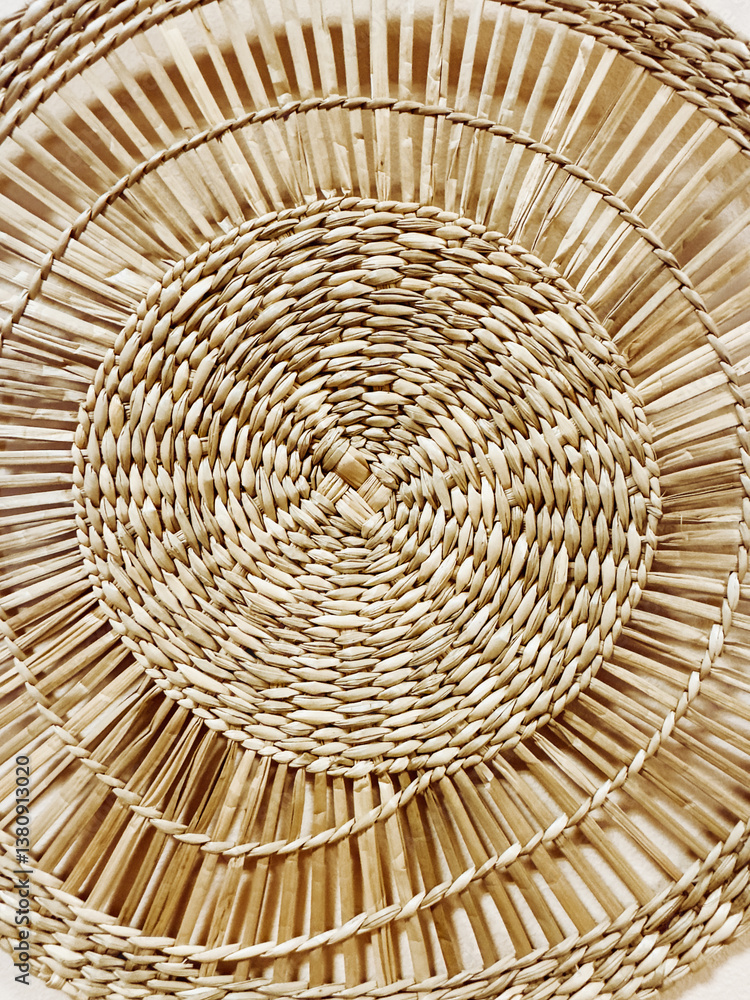 Fototapeta premium Close-up of a handwoven rattan or wicker texture. Natural material with warm, earthy tones, perfect for interior design, eco-lifestyle, or boho-inspired concepts.