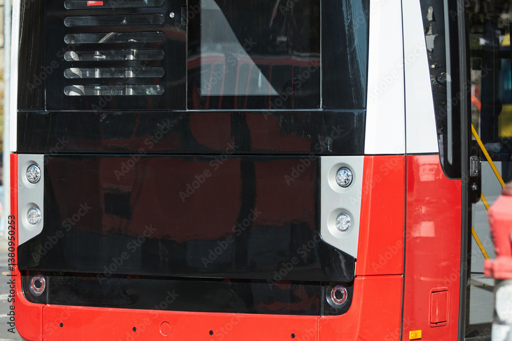 Red bus for public transportation on city streets.
