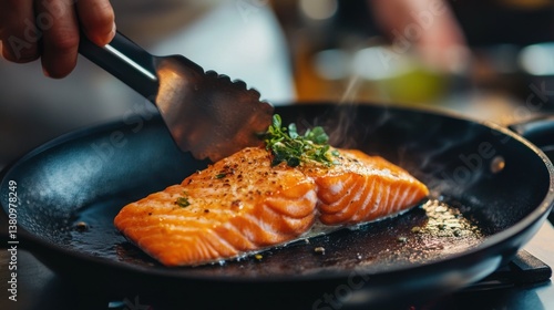 Obraz na płótnie Cooking Salmon Fillet in a Pan with Fresh Herbs and Seasoning w salonie