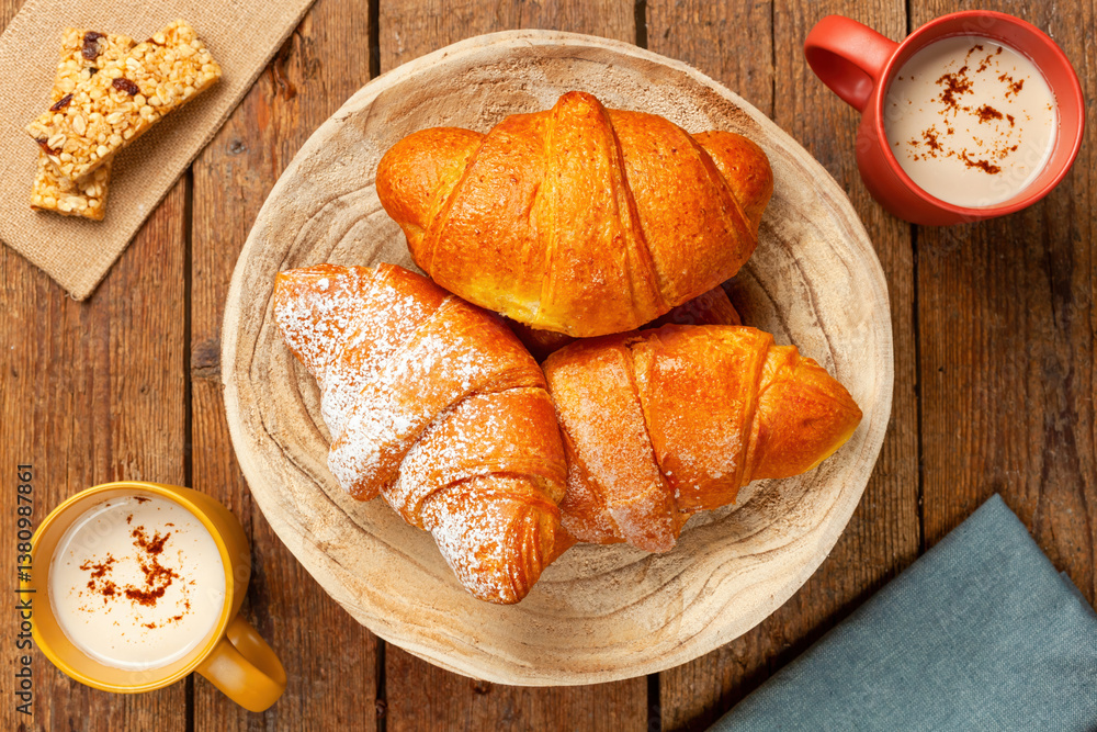 Fototapeta premium Delicious freshly baked croissants and cappuccino enjoying breakfast