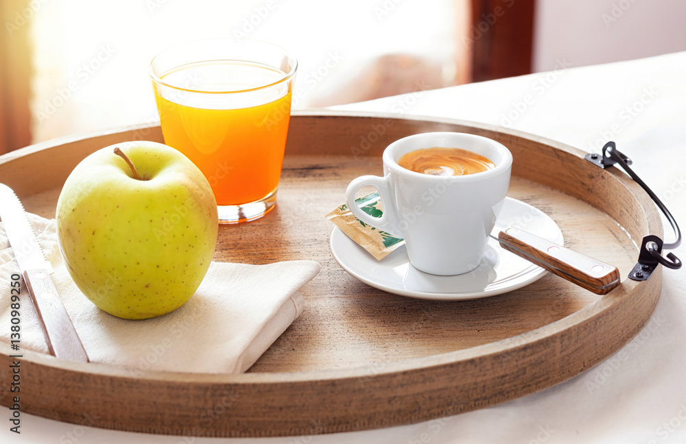Delicious breakfast with coffee, juice and apple on wooden tray Delicious breakfast with coffee, juice and apple on wooden tray