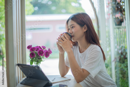 Happy young Asian woman making video call to her friend who is working remotely and studying online on her laptop from home. Free Download Happy young Asian woman making video call to her friend who is working remotely and studying online on her laptop from home. - GFXLoad