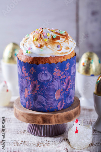 Obraz na płótnie Easter cake, chocolate eggs in gold foil and chicken-shaped candles on a light background. w salonie