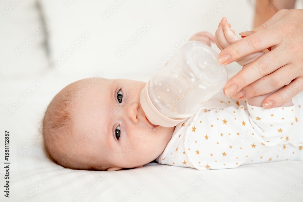 Mom's hand holds a bottle of milk for a newborn baby. Small child with bottle close-up, High quality 4k footage Mom's hand holds a bottle of milk for a newborn baby. Small child with bottle close-up, High quality 4k footage
