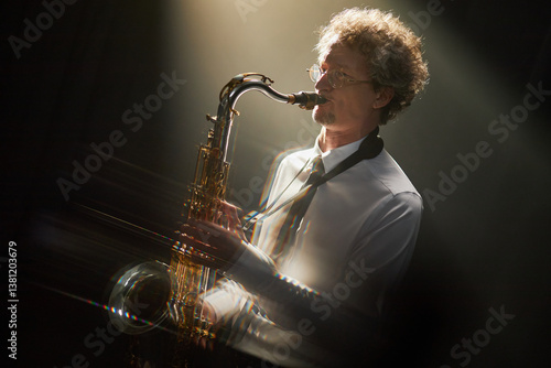 Canvas Print Focused adult male jazz musician wearing in white shirt and black tie playing sa
