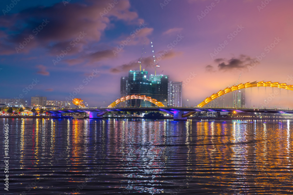 Naklejka premium 29 March 2025 Fire Breathing Dragon Bridge at Da Nang over a river, wonderful colours of the Sky at night and river in Da Nang Vietnam. thousands of spectators line up on Saturday and Sunday night 