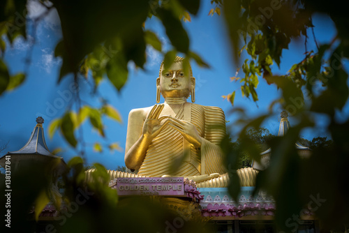 Giant gold-plated Buddha statue in a Buddhist temple in Dambulla, Sri Lanka. 