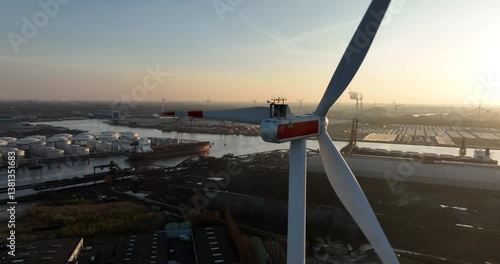 Wind turbine in the port of Amsterdam. Amsterdam Seaport, sustainable energy. Petrochemical silos.