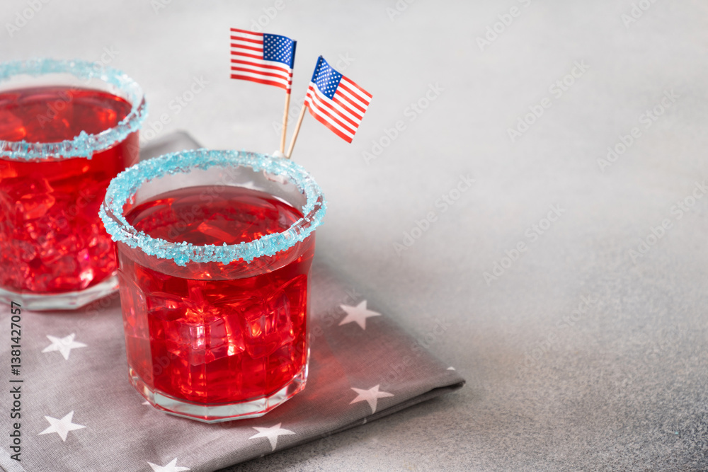 Patriotic red pomegranate Margarita cocktails on gray background. Festive beverages for Independence Day July 4th. Rimmed drinks. Close up. Copy space.