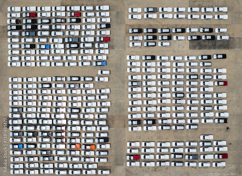 Aerial top view rows of new cars parked in distribution center on car factory, Automobile and automotive car parking lot for commercial business industry to dealership for sale at port terminal Aerial top view rows of new cars parked in distribution center on car factory, Automobile and automotive car parking lot for commercial business industry to dealership for sale at port terminal