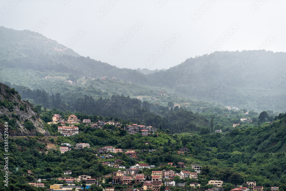 Fototapeta premium Kotor Skurda canyon cliff mountains by old fort fortress trail hike in rain with cityscape skyline of old town Montenegro coastal city in summer