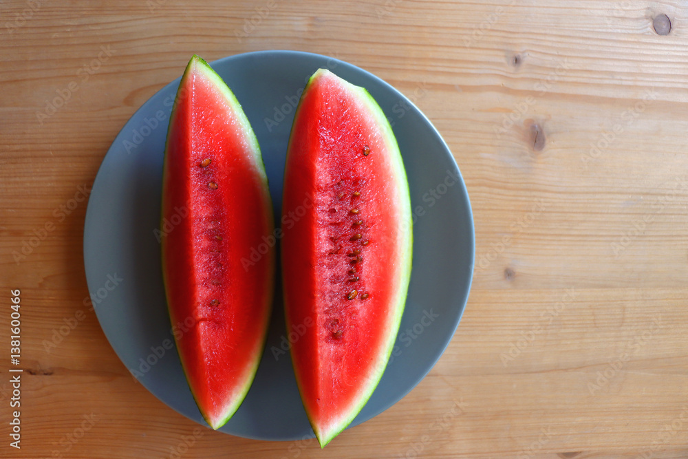 Plate with two watermelon slices on the table. Top view.