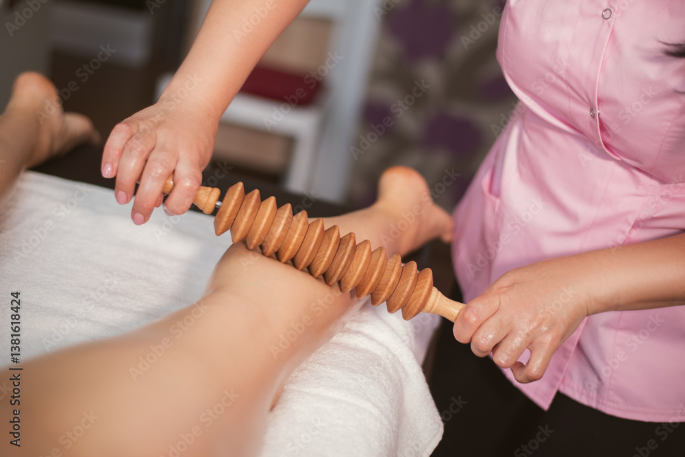 Obraz premium The process of anti-cellulite massage with wooden massagers