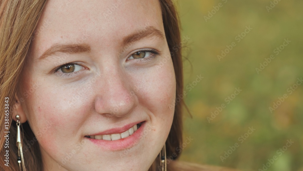 Fototapeta premium Teenage girl with auburn hair, warm brown eyes, radiating soft confidence and genuine happiness in close up portrait