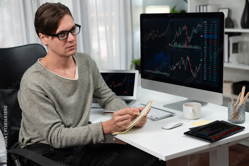 Smart businessman trader in casual day analyzing with profit value of dynamic increased stock exchange market graph, taking note on paper for profitable investment list at modern office. Pecuniary. Smart businessman trader in casual day analyzing with profit value of dynamic increased stock exchange market graph, taking note on paper for profitable investment list at modern office. Pecuniary.