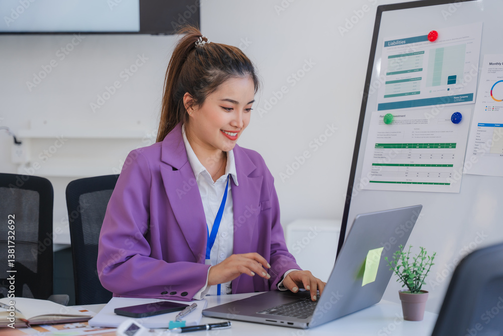 Smiling Asian Businesswoman Working at Desk Smiling Asian Businesswoman Working at Desk