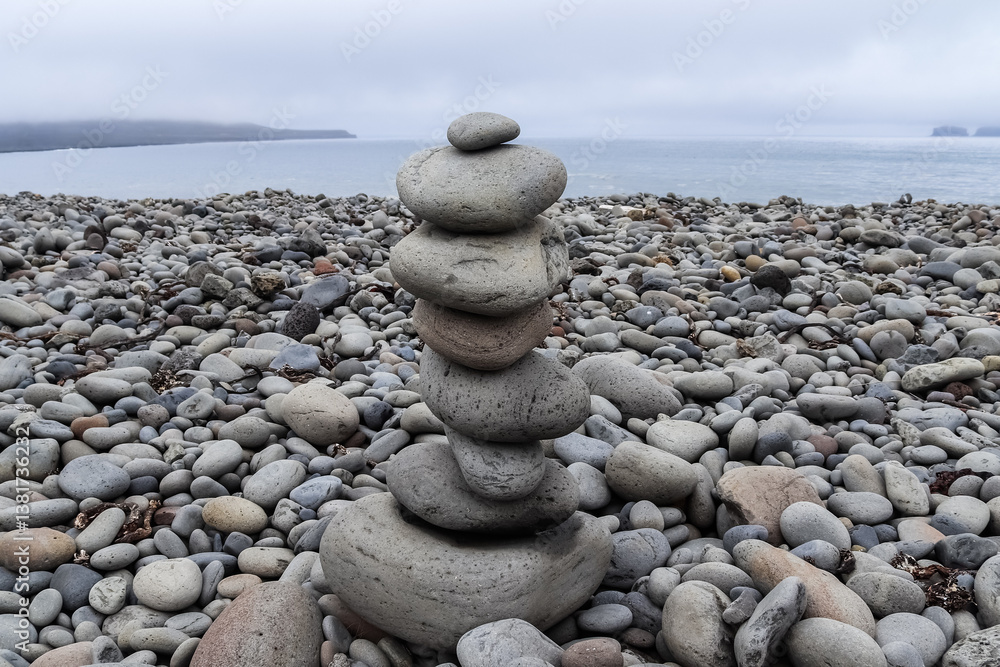 Balancing stones creating a zen atmosphere on a pebble beach in Iceland Balancing stones creating a zen atmosphere on a pebble beach in Iceland