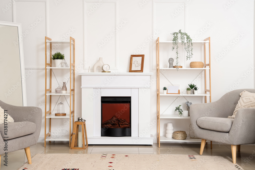 Fototapeta premium Modern fireplace with shelving units and armchairs in living room