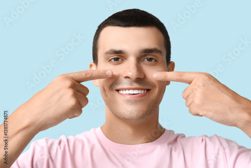 Ill young man pointing at n...