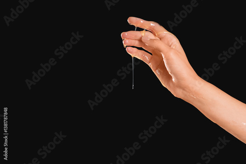 Human hand dripping golden ...