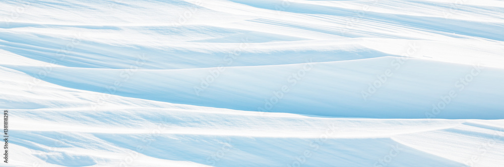 Snow texture. Wind sculpted patterns on snow surface. Wind in the tundra and in the mountains on the surface of the snow sculpts patterns and ridges (sastrugi). Arctic, Polar region. Winter background
