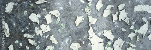 Obraz na płótnie Peeling paint on the wall. Panorama of a concrete wall with old cracked flaking paint. Weathered rough painted surface with patterns of cracks and peeling. Panoramic texture for background and design. w salonie