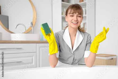 Young chambermaid cleaning ...