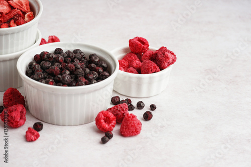 Fototapeta Naklejka Na Ścianę i Meble -  Bowls with tasty freeze-dried fruits on light background