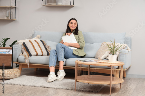 Young woman with laptop sit...