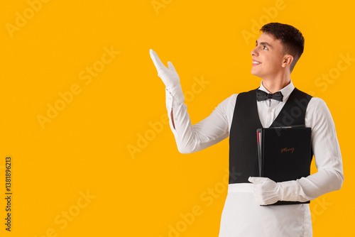 Young male waiter with menu...