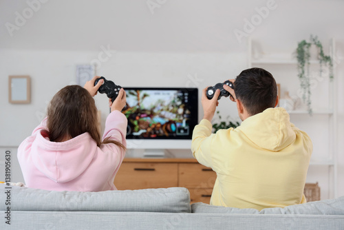Young couple playing video ...