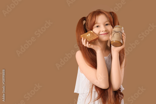 Teenage redhead girl holdin...